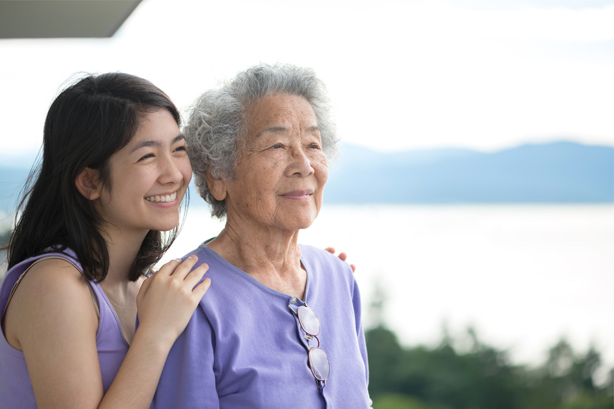 Happy older Asian woman with her adult daughter.