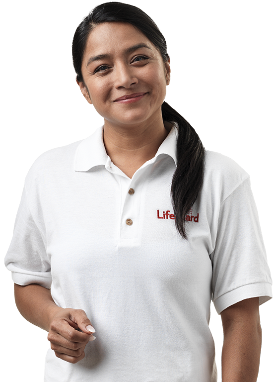 A brunette woman wearing a white Lifeguard polo.